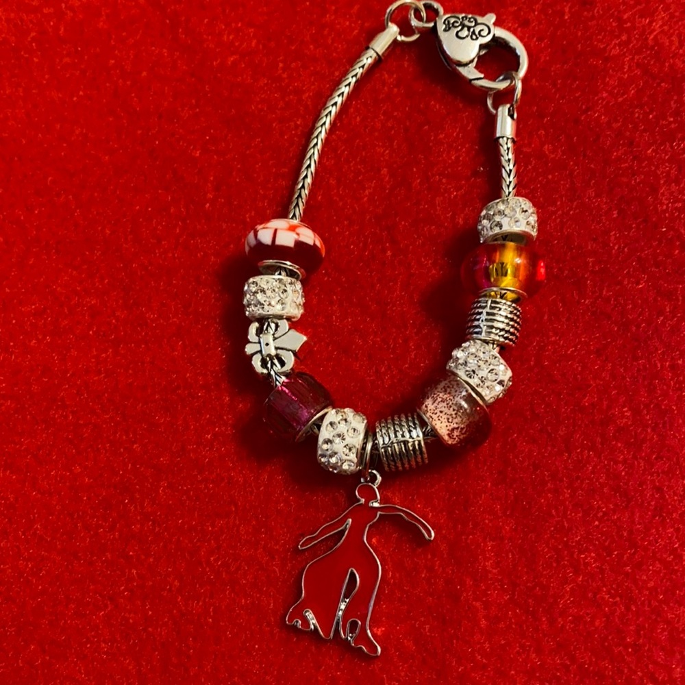 Charm bracelet with fortitude hanging charm.
